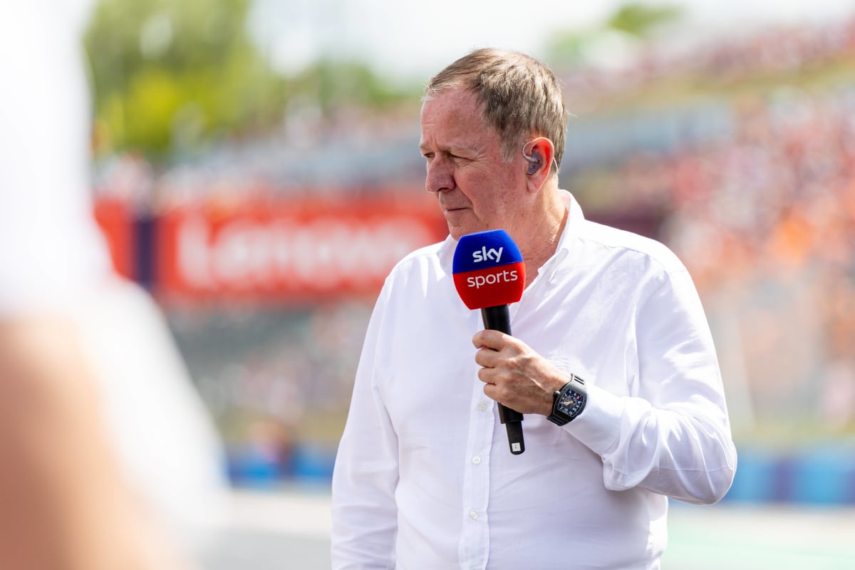 Martin Brundle speaks into a Sky Sports microphone