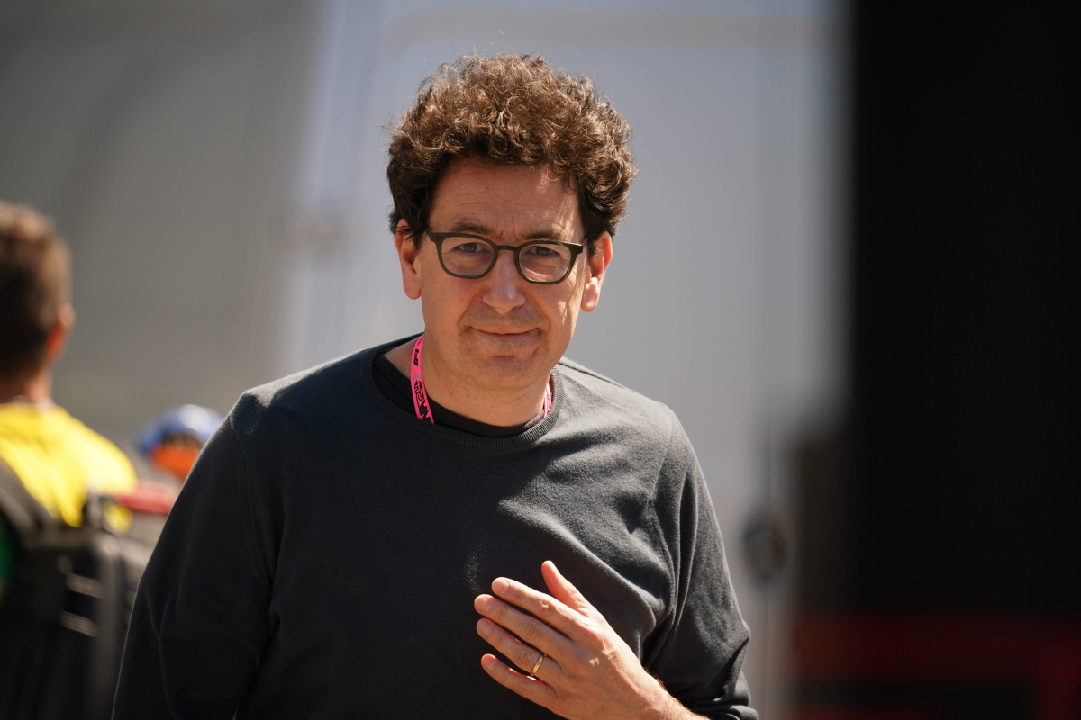 Mattia Binotto smiles in a black sweater