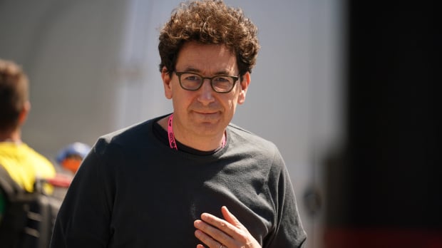 Mattia Binotto smiles in a black sweater