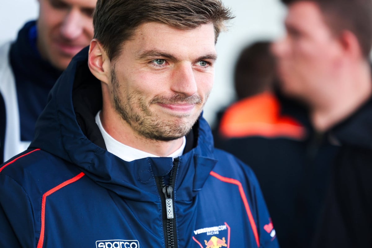 Verstappen smirking in a Verstappen.com jacket during his gt appearance at the Nurburgring