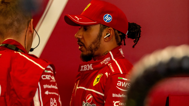 Lewis Hamilton in a Ferrari race suit in the Ferrari garage