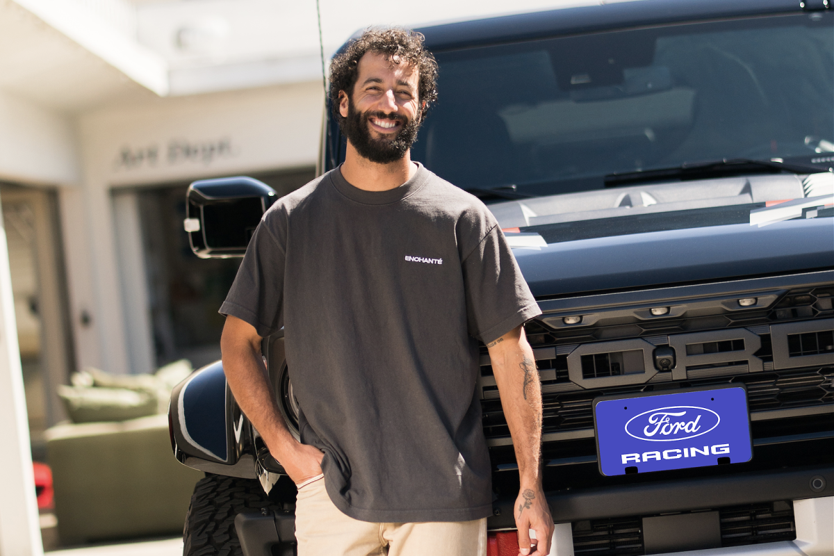 Daniel Ricciardo looking at a Ford logo