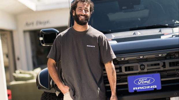 Daniel Ricciardo looking at a Ford logo
